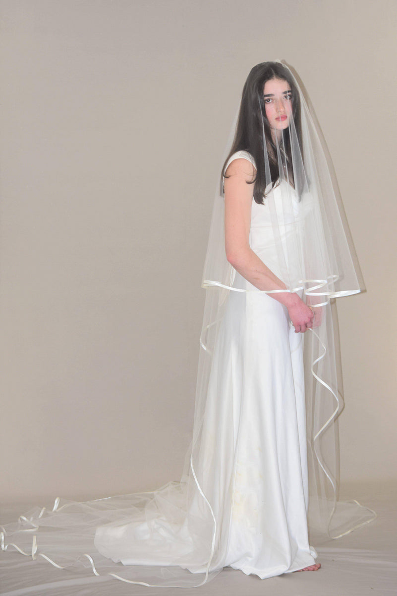 http://weddingveil.com/cdn/shop/products/Cascading-Two-Tier-Cathedral-Satin-Trim-Veil_530f73cb-de4c-4a46-8c25-408c4a5bf234_1200x1200.jpg?v=1658934132